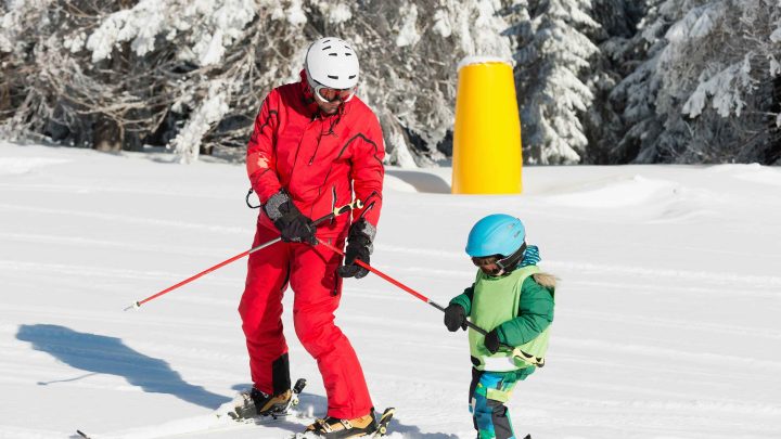 Ski teacher study child how to ride ski