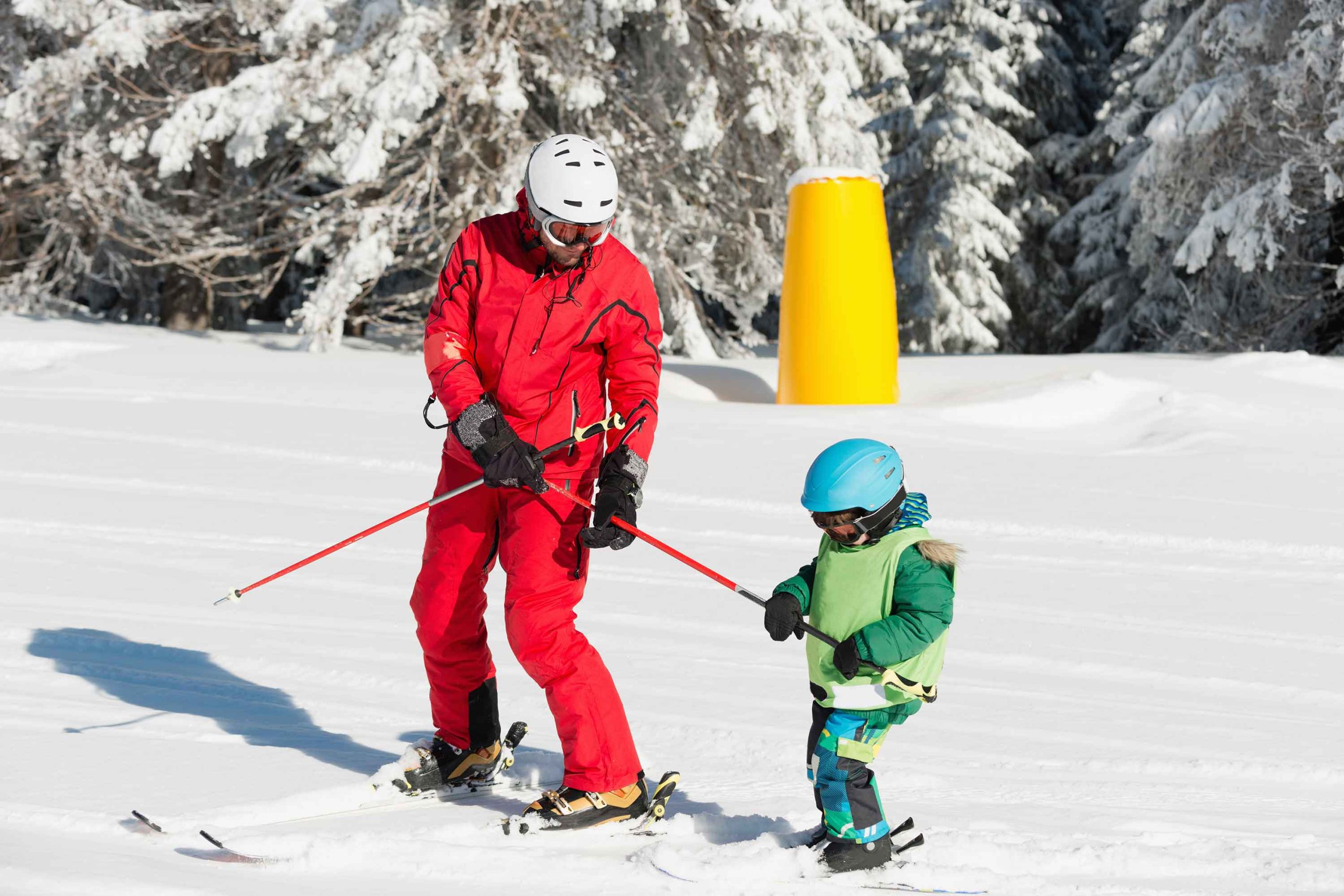 Ski teacher study child how to ride ski